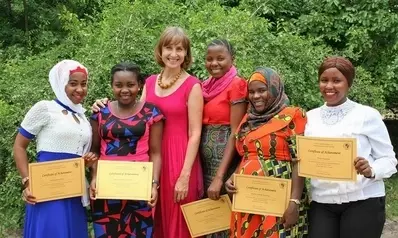 English course graduates with their teacher